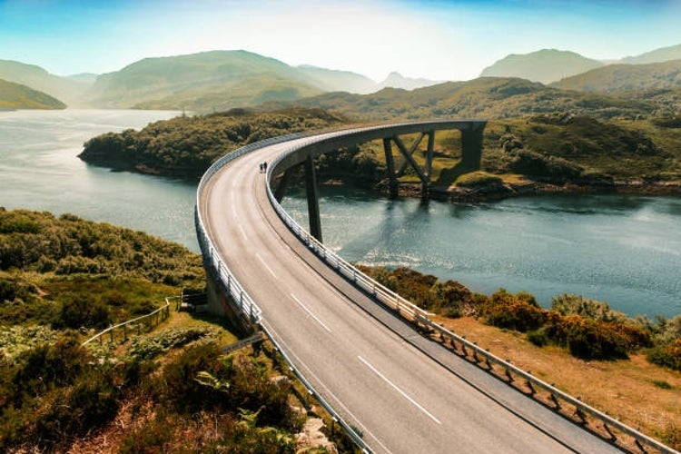 Kylesku Bridge spanning the tranquil waters of Loch a’ Chairn Bhain, a stunning highlight along the scenic North Coast 500 road trip in northern Scotland.jpg