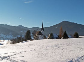 photo of Unterammergau town in beautiful autumnal nature and blue sky with clouds in Bavaria, Germany.