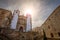 Photo of vView of the baroque church of San Francisco Javier de Caceres, Spain, in the Plaza de San Jorge at sunset with the sun backlit and pigeons in the sky .