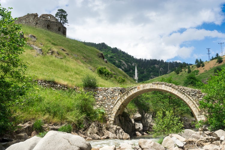 Photo of arch bridge with minaret in the old Greek church. Giresun ,Turkey.