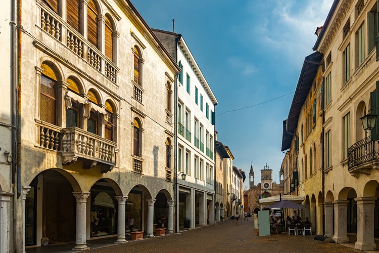 Photo of typical old town street in historical center of Pordenone in sunny autumn day, Italy.