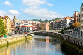 Photo of aerial view of Vizcaya bridge over the river and cityscape at Portugalete, Spain.