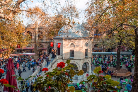 Koza Han tea gardens and mosque in Koza Han Silk Bazaar. Koza Han is historical place from Ottoman times in Bursa, Turkey, and a popular tourist attraction.