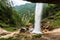 Peričnik Waterfall in Vrata Valley: Majestic beauty unveiled as sunlight illuminates cascading veil, shimmering rocks, and pristine surroundings. Nature's artistry awaits your discovery.