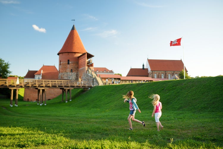 Photo of kids playing near Kaunas castle, Lithuania.