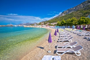 Photo of aerial view on Adriatic Sea and Baska Voda place in Makarska Riviera, Dalmatia region, popular tourist summer resort in Croatia.