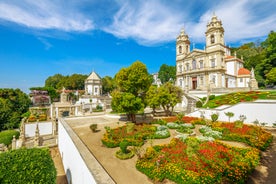 Photo of Ourem Castle from the valley with a blue sky, the valley is covered with trees and plants, Portugal.