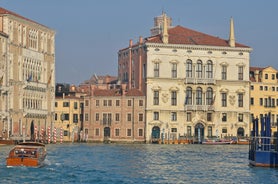 Famous buildings, gondolas and monuments by the Rialto Bridge of Venice on the Grand Canal, Italy.