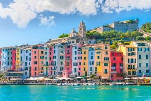 Photo of Riomaggiore with colorful houses along the coastline, one of the five famous coastal village in the Cinque Terre National Park, Liguria, Italy.