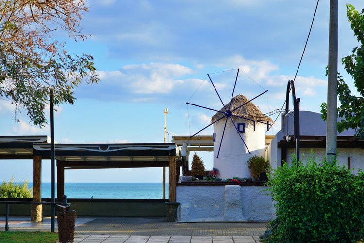 Photo of view of a windmill on the coastline in Alexandroupoli, Greece..