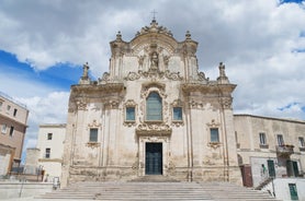 Photo of panoramic view of the ancient town of Matera (Sassi di Matera), European Capital of Culture 2019, in beautiful golden morning light with blue sky and clouds, Basilicata, southern Italy.