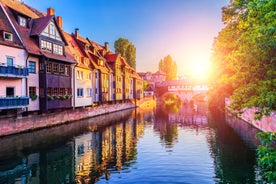 Photo of scenic summer view of the German traditional medieval half-timbered Old Town architecture and bridge over Pegnitz river in Nuremberg, Germany.