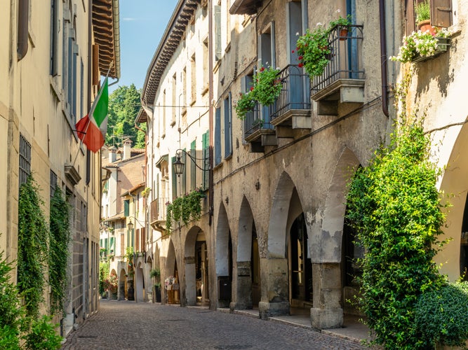 View of the arcades of the ancient village of Asolo in summer, Treviso, Italy