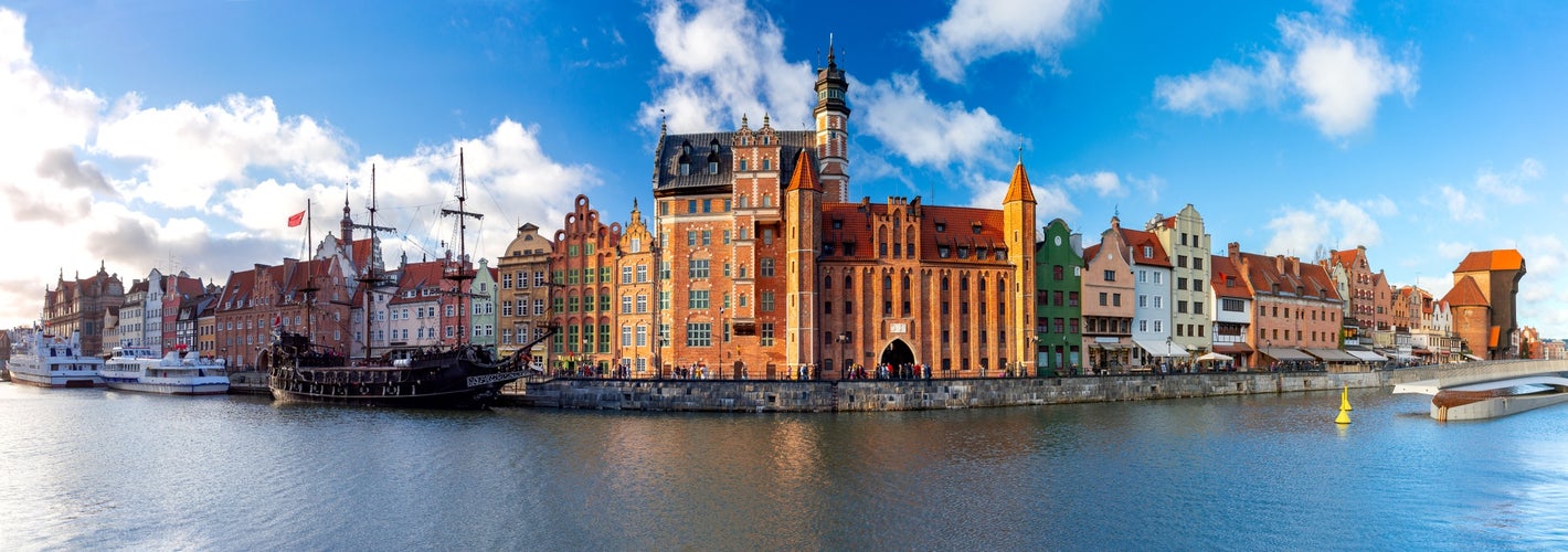 Photo of panorama of the facades of old medieval houses on the promenade in Gdansk, Poland.