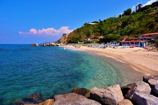 photo of an aerial view of Parghelia in Italy. Overview of seabed seen from above, transparent water and beach with umbrellas.