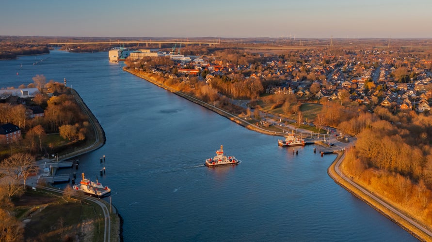 Panorama aerial view of Kiel Canal and canal ferry near Rendsburg, Schacht-Audorf ferry terminal, Schleswig-Holstein, Germany.