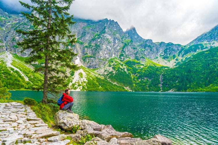 Beautiful Woman in Red Jacket Enjoying Scenic Mountain Lake View in Zakopane, Poland