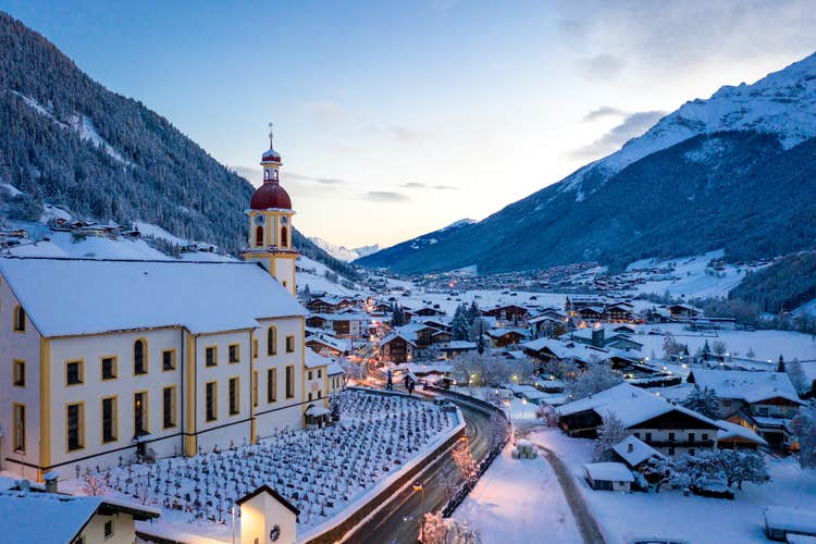 photo of winter before sunrise cityscape in the Austrian town of Neustift and the town center and the church in Austria.