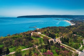 Photo of Saint Anastasia Island in Burgas bay, Black Sea, Bulgaria. Lighthouse tower and old wooden buildings on rocky coast.