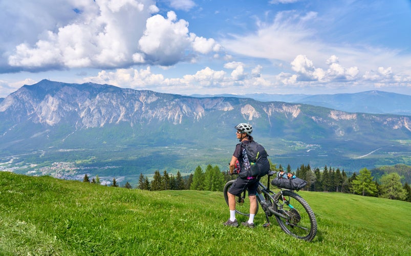 active senior woman on a mountain bike tour in the carinthian alps above Villach in Austria