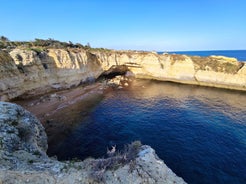 Photo of wide sandy beach in white city of Albufeira, Algarve, Portugal.