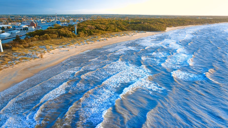 Western beach in Kolobrzeg. Photo from a drone on a clear September day at the beach and rough sea with waves.