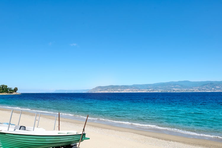 Sandy beach in Messina with views of Calabria and the Messina strait. Italy.