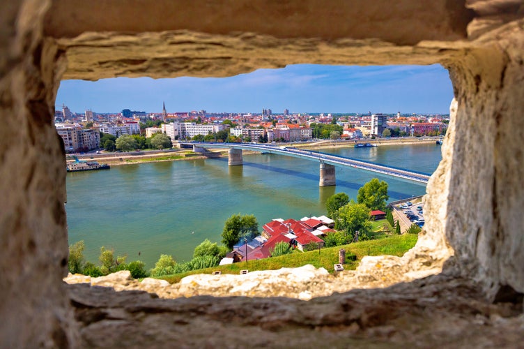 Photo of city Of Novi Sad and Danube river aerial view through stone window from Petrovaradin, Vojvodina region of Serbia.