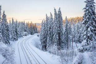 Photo of landscape with mountains, river and buildings in Lillehammer town, Norway.