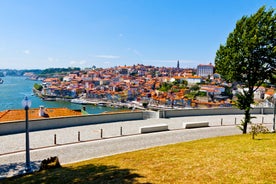 Porto, Portugal old town ribeira aerial promenade view with colorful houses, Douro river and boats.