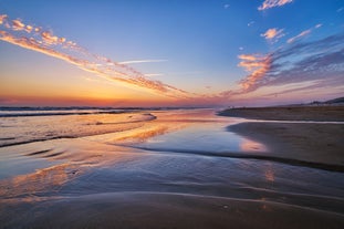 Photo of aerial view of Costa da Caparica coastline of glorious sandy beaches, powerful Atlantic waves, Portugal.