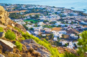 Photo of aerial view of black Perissa beach with beautiful turquoise water, sea waves and straw umbrellas, Greece.