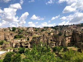 Hot air balloons flying over Uchisar Castle. Cappadocia. Nevsehir Province. Turkey.