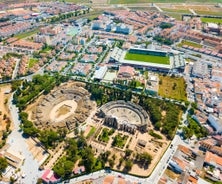 Photo of aerial view of Jaen with cathedral and Sierra Magina mountains on background, Andalusia, Spain.