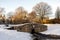 Photo of A small water stream coming under a scenic stone bridge in Westburn park, Aberdeen, Scotland .