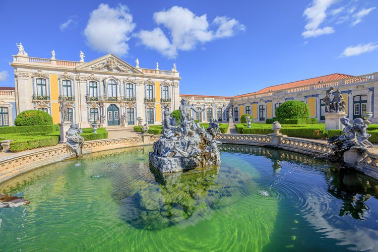 Photo of Baroque facade of Queluz National Palace and Neptune Fountain in Sintra, Lisbon district, Portugal.