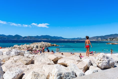 City beach of Cannes with unidentified people.