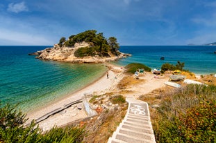 Photo of aerial view of Pythagorio port with colourful houses and blue sea, Samos island, Greece.