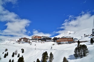 Photo of The mountain village at the Austrian ski resort Soelden on a cold and sunny winter day.