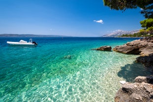 Photo of aerial view on Adriatic Sea and Baska Voda place in Makarska Riviera, Dalmatia region, popular tourist summer resort in Croatia.