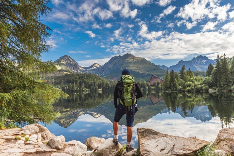 photo of hiker looking at high Tatras near the lake Štrbské Pleso, Slovakia.