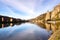 photo of view of Rocher Bayard with its reflection on the Meuse river in Dinant, Belgium.