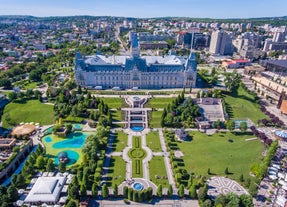 Photo of Water fountain in central square in Iasi town, Cultural Palace in background, Moldavia, Romania.