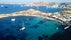 Aerial drone bird's eye view from famous beach of Paraga featuring famous night club of Skorpios and Santanna with largest pool in Europe, Mykonos island, Cyclades, Greece.