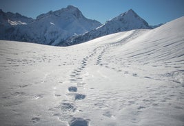 Photo of aerial view of beautiful winter landscape of Les Deux Alpes surrounded by mountains, France.