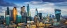 London, England - Panoramic skyline view of Bank and Canary Wharf, central London's leading financial districts with famous skyscrapers at golden hour sunset with blue sky and clouds.