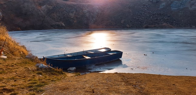 photo of view of Frozen lake with boats in Tulcea, Romania.