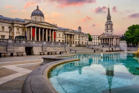 London, England - Panoramic skyline view of Bank and Canary Wharf, central London's leading financial districts with famous skyscrapers at golden hour sunset with blue sky and clouds.