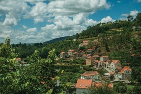 photo of Poço da Broca waterfall in Serra da Estrela Natural Park, Barriosa, municipality of Seia in Portugal, with a viewpoint in the foreground, at the end of a spring day.