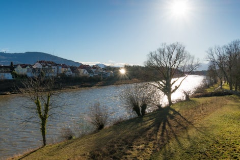 photo of VIEW OF View from the bridge between Oberndorf in Austria and Laufen in Germany on a sunny morning in winter,Oberndorf bei Salzburg Austria.